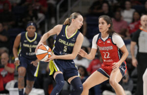Dallas Wings guard Paige Bueckers controls the ball as Washington Mystics guard Sonia Citron defends during a 2025 WNBA game.