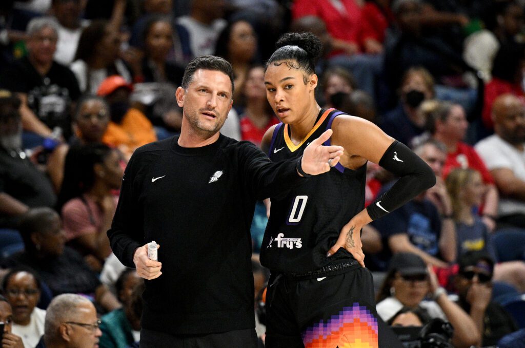 Phoenix Mercury head coach Nate Tibbetts talks to forward Satou Sabally on the the sideline during a 2025 WNBA game.