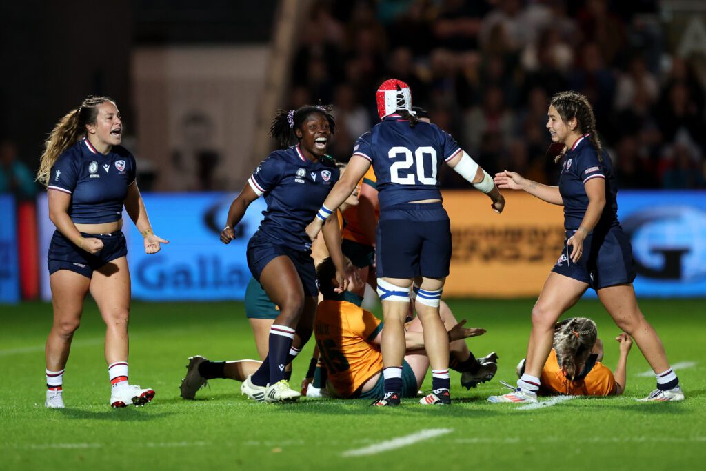 Team USA rugby players celebrate an Australia turnover during their second group-stage game at the 2025 Women's Rugby World Cup.