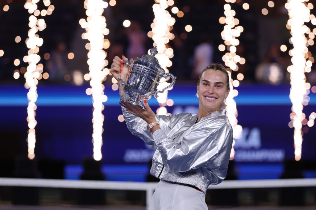 World No. 1 tennis player Aryna Sabalenka poses with her 2025 US Open trophy.