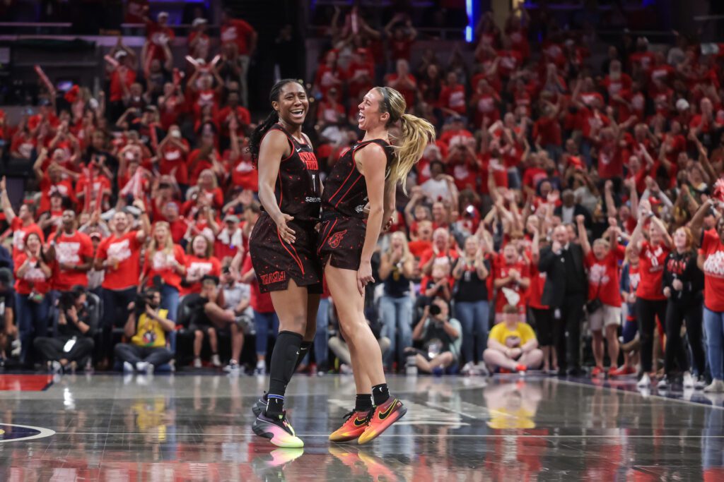 Indiana Fever teammates Aliyah Boston and Lexie Hull chest-bump in celebration of their Game 2 win in the first round of the 2025 WNBA Playoffs.