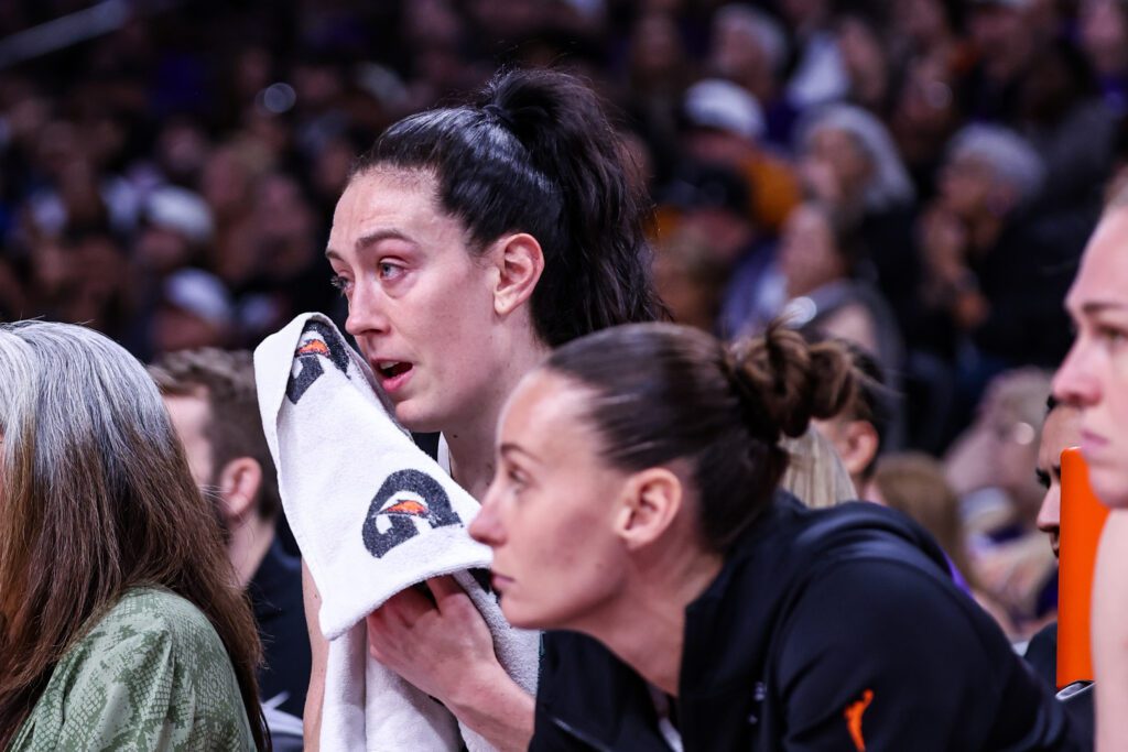 An emotional Breanna Stewart sits on the bench after the New York Liberty star was injured in Game 1 of the 2025 WNBA Playoffs.