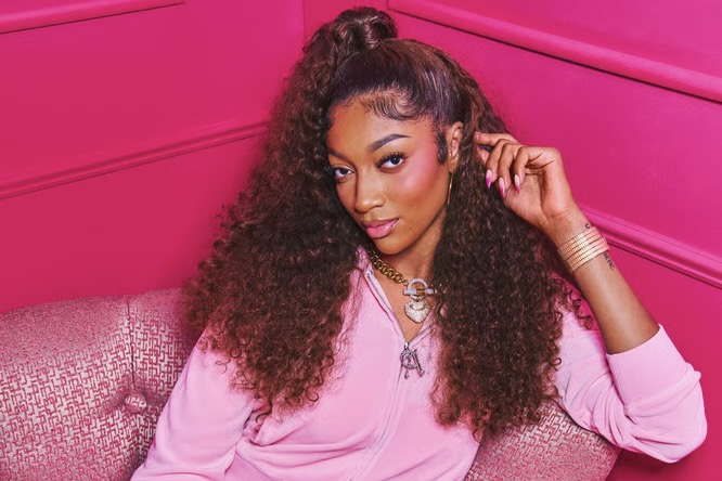 Chicago Sky forward Angel Reese poses in pink Juicy Couture as part of her new partnership with the fashion brand.