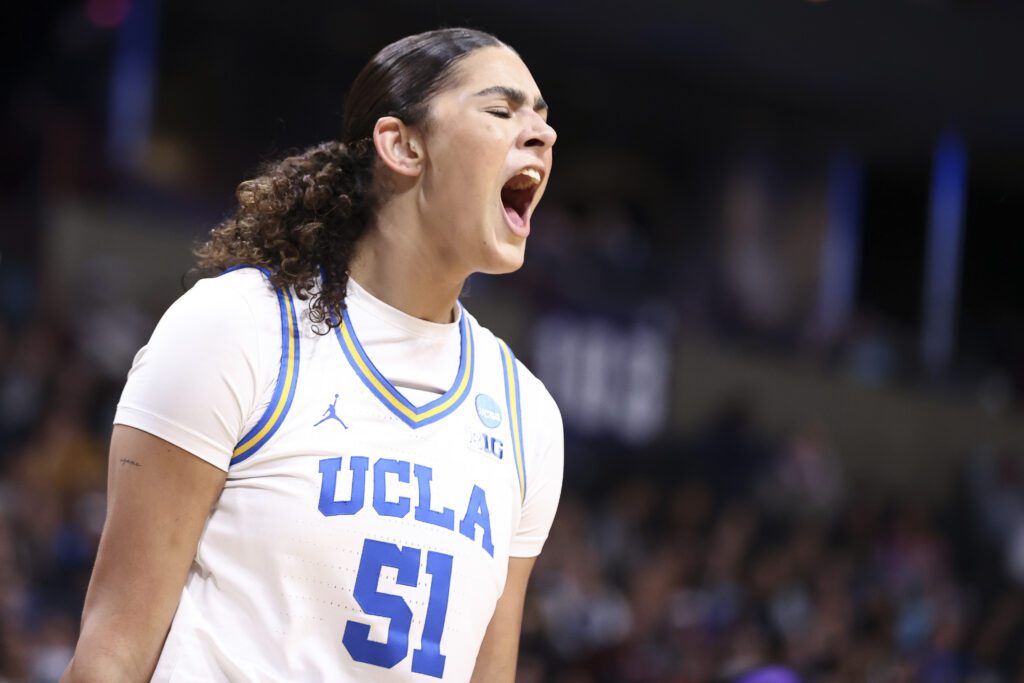 UCLA basketball center Lauren Betts yells in triumph after a play during a 2025 Elite Eight game.