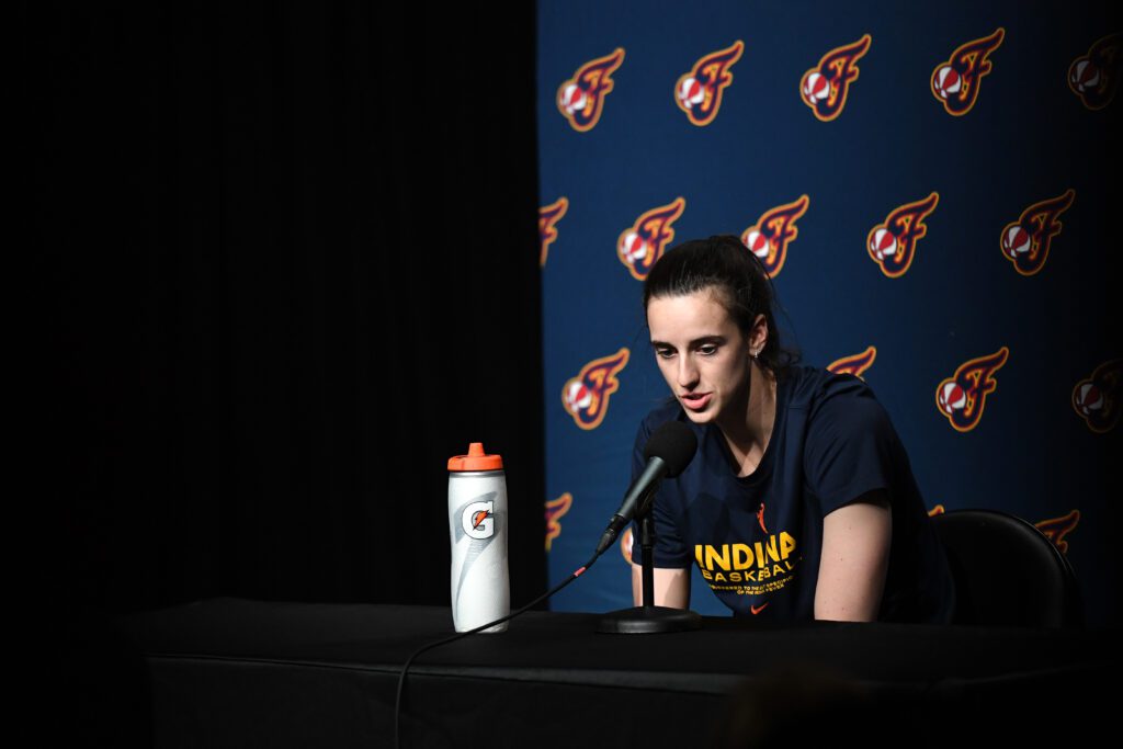 Indiana Fever guard Caitlin Clark speaks to media before a 2025 WNBA game.