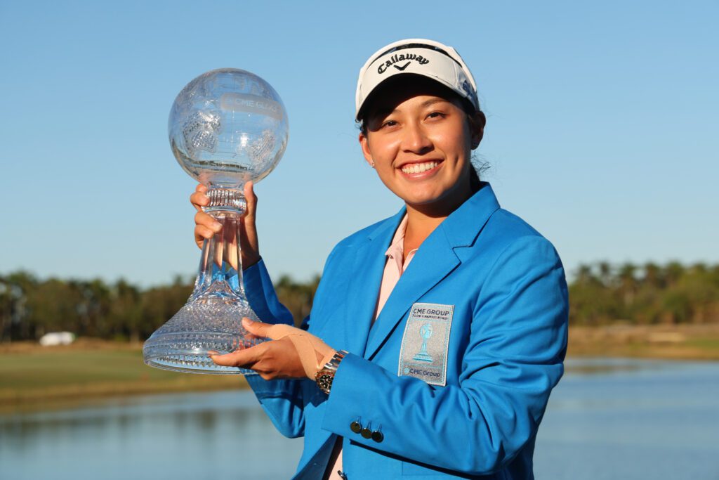 Thai golf star Jeeno Thitikul poses holding her 2024 CME Group Tour Championship trophy.