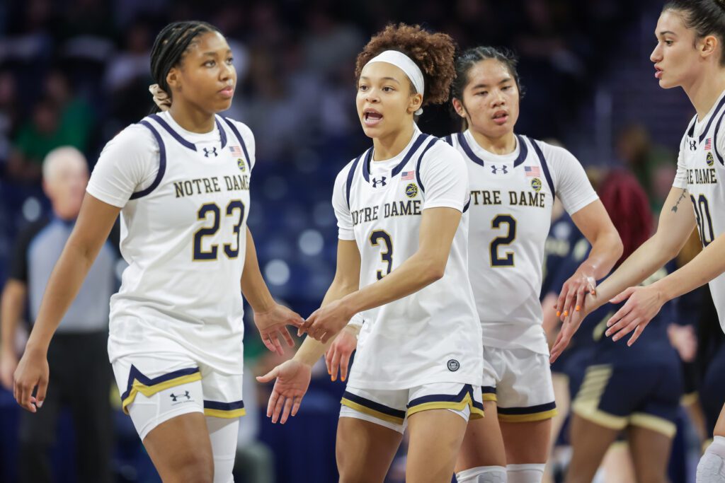 Notre Dame guard Hannah Hidalgo high-fives teammates during a 2025/26 NCAA basketball game.