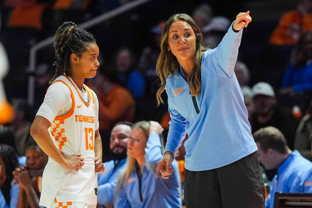 Tennessee basketball head coach Kim Caldwell instructs guard Mia Pauldo on the sideline during a 2025 NCAA preseason exhibition game.