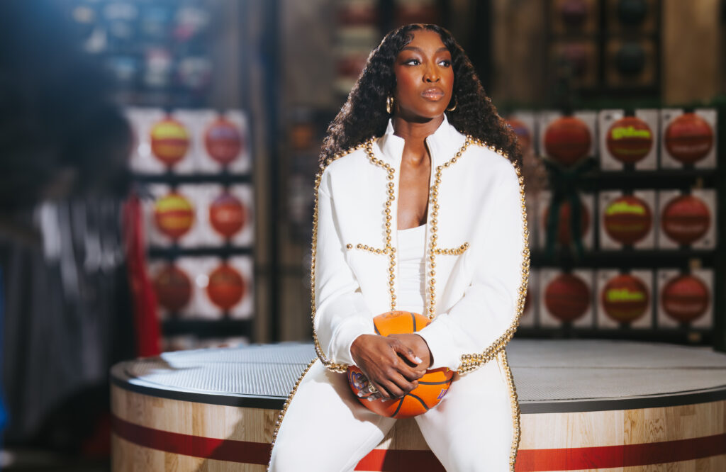 LSU star Flau'jae Johnson poses holding a basketball for a DICK'S Sporting Goods promotion.