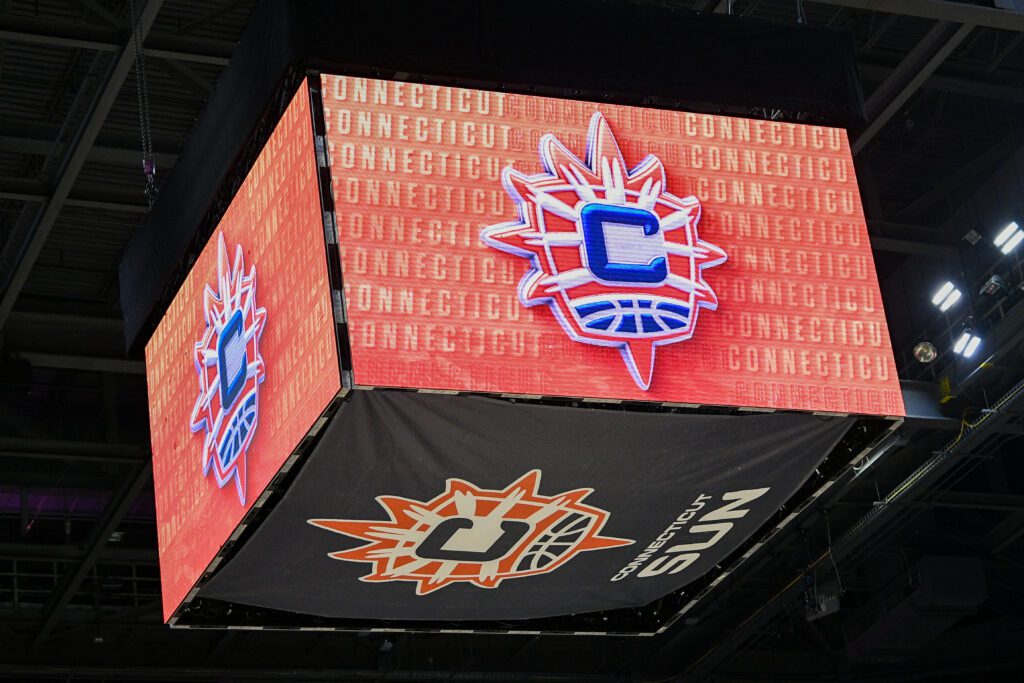 The Mohegan Sun Arena jumbotron displays the Connecticut Sun logo before a 2025 WNBA game.