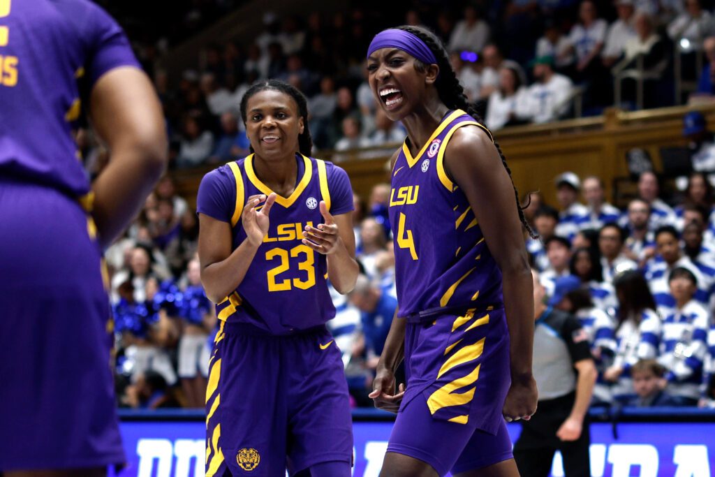 LSU stars MiLaysia Fulwiley and Flau'jae Johnson celebrate a play during a 2025/26 NCAA basketball game.