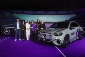 Mercedes-Benz board member Mathias Geisen, WTA chair Valerie Camillo, WTA Ventures CEO Marina Storti, WTA founder Billie Jean King, former WTA star Andrea Petkovic, and Mercedes-Benz VP Christina Scheck pose next to a car to announce the automaker's tennis partnership.