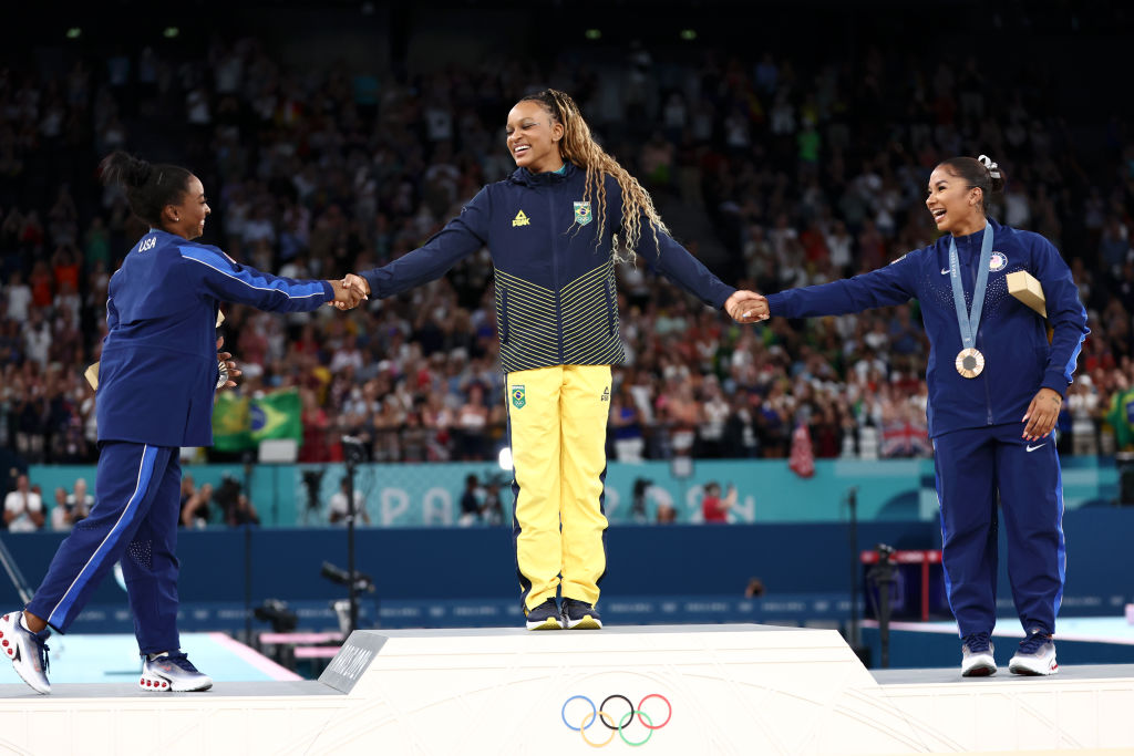 Gold medalist Rebeca Andrade (C) of Team Brazil, silver medalist Simone Biles (L) of Team United States and bronze medalist Jordan Chiles (R) of Team United States celebrate on the podium at the Artistic Gymnastics Women's Floor Exercise Medal Ceremony on day ten of the Olympic Games Paris 2024 at Bercy Arena on August 05, 2024 in Paris, France.