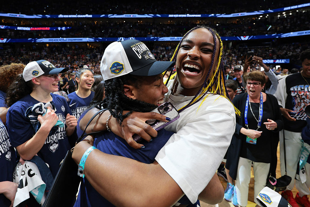 KK Arnold #2 of the UConn Huskies celebrates with former UConn Huskies teammate Aaliyah Edwards #24 of the Washinton Mystics after defeating the South Carolina Gamecocks during the Division I Women's Basketball Championship game at Amalie Arena on April 6, 2025 in Tampa, Florida.