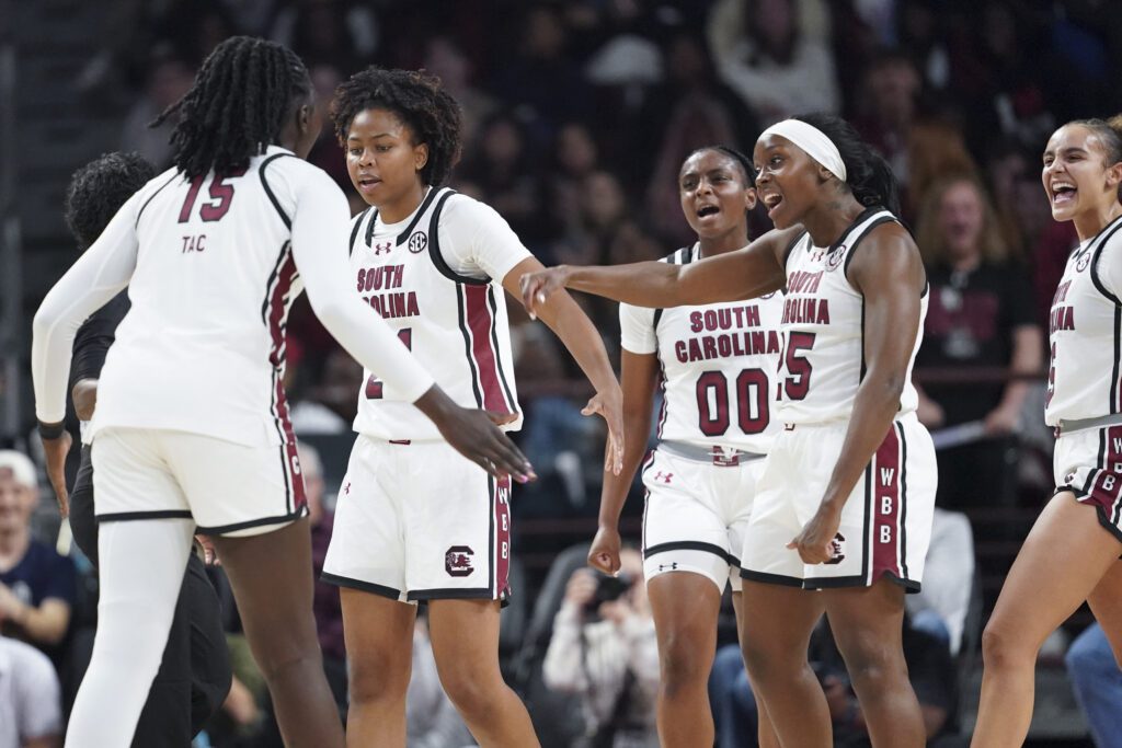 South Carolina players celebrate a play during a 2025/26 NCAA basketball game.