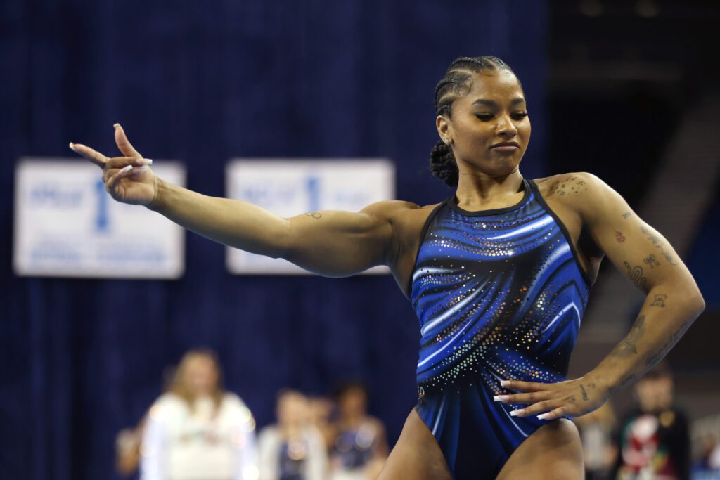 UCLA gymnast Jordan Chiles strikes a pose during her floor routine at a December 2025 exhibition meet.