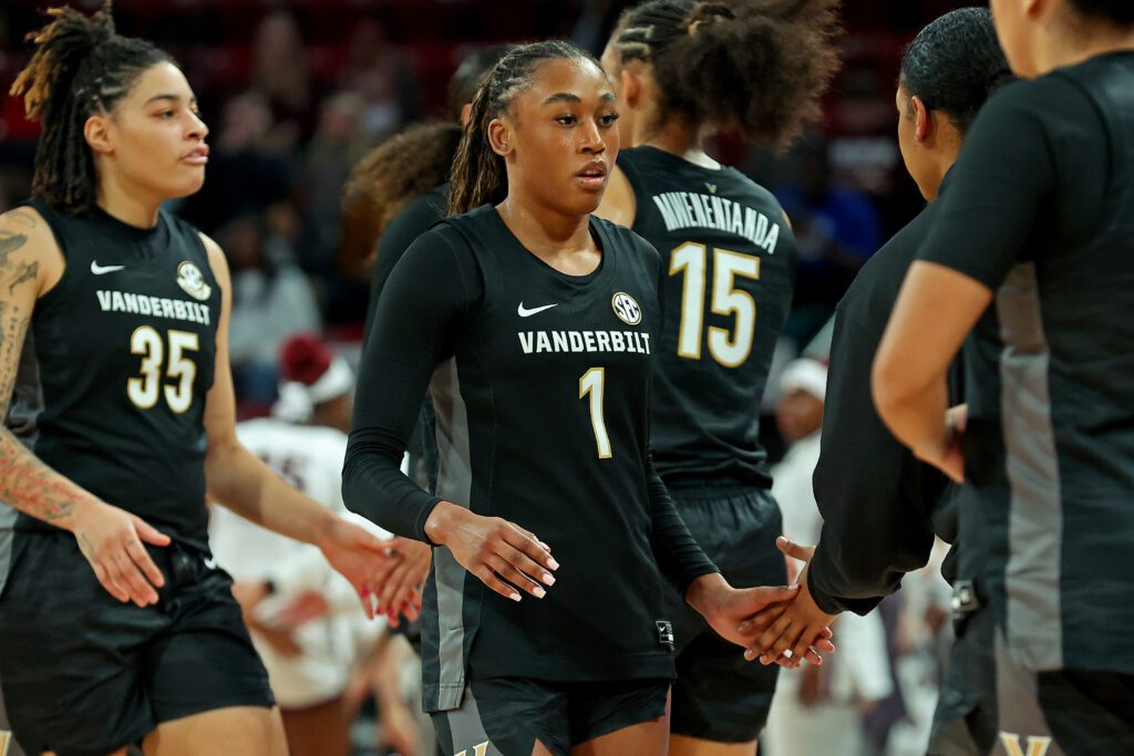 Vanderbilt sophomore guard Mikayla Blakes high-fives a coach during a timeout in a 2025/26 NCAA basketball game.