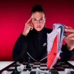 Spain soccer star Alexia Putellas poses over a chess board holding her Nike Player Edition Phantom 6 cleat