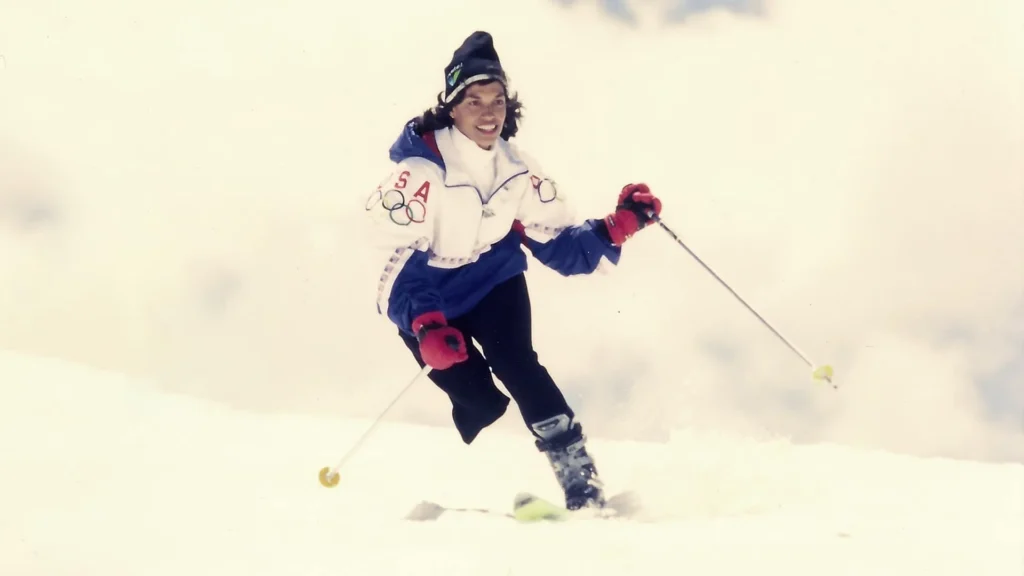 USA Paralympian Bonnie St. John smiles as she skis down the slope.