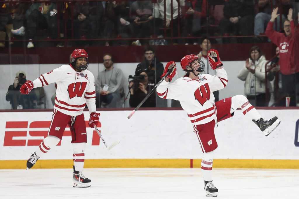 Wisconsin stars Laila Edwards and Caroline Harvey celebrate a goal during the 2025 NCAA hockey championship game.