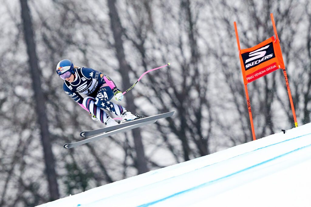 USA ski star Lindsey Vonn catches air on a downhill run at a 2026 FIS Alpine World Cup tour stop.