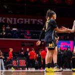 Michigan sophomore Syla Swords high-fives senior Brooke Quarles Daniels as she is introduced before a 2025/26 NCAA basketball game.