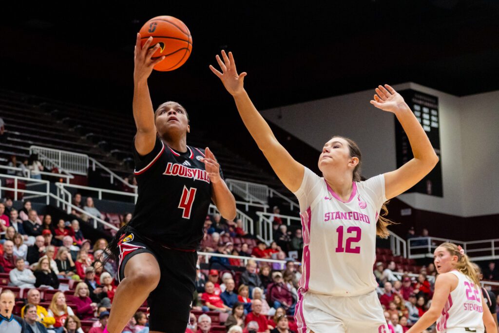 Louisville sophomore forward Mackenly Randolph lays up a shot while Stanford freshman forward Lara Somfai defends during a 2025/26 NCAA basketball game.