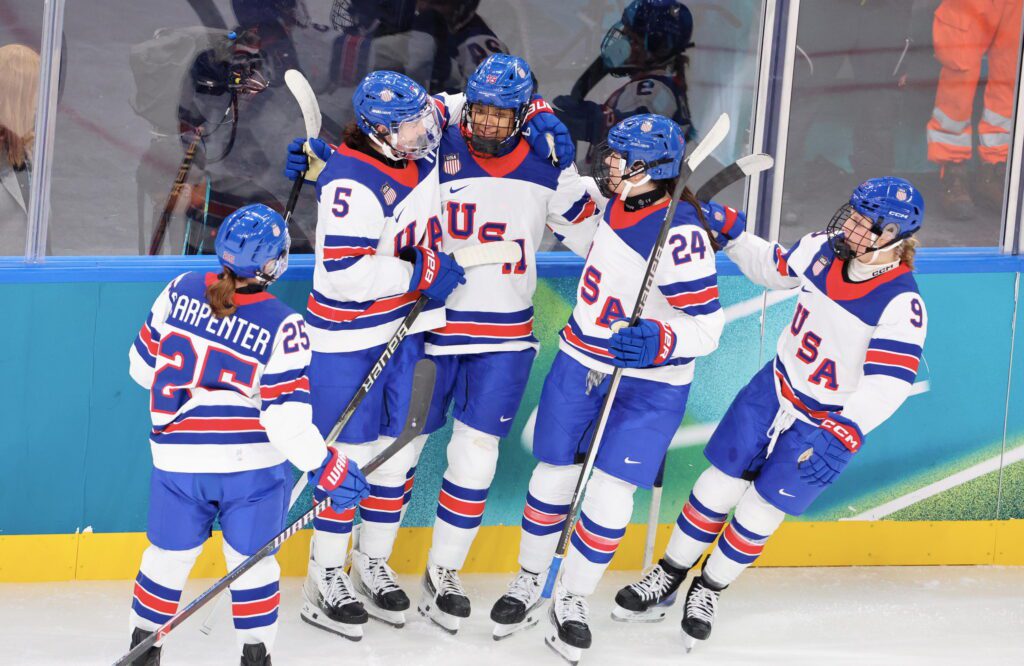 USA Hockey defender Laila Edwards celebrates her first Olympic goal with her teammates at the 2026 Winter Games.