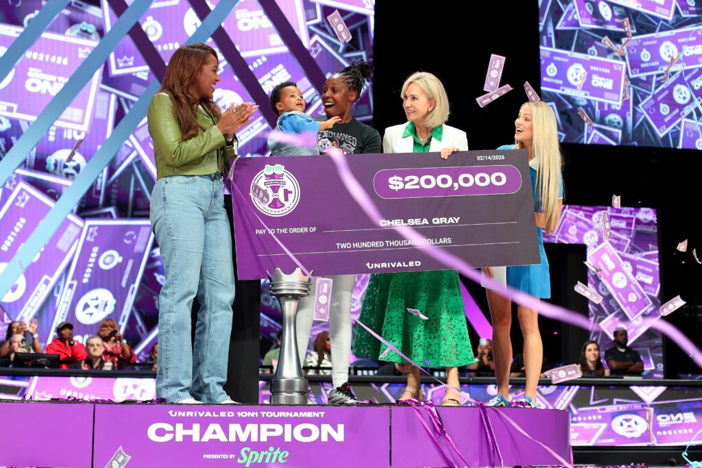 Unrivaled Basketball Commissioner Micky Lawler presents Rose BC guard Chelsea Gray with the 1v1 tournament winner's check.