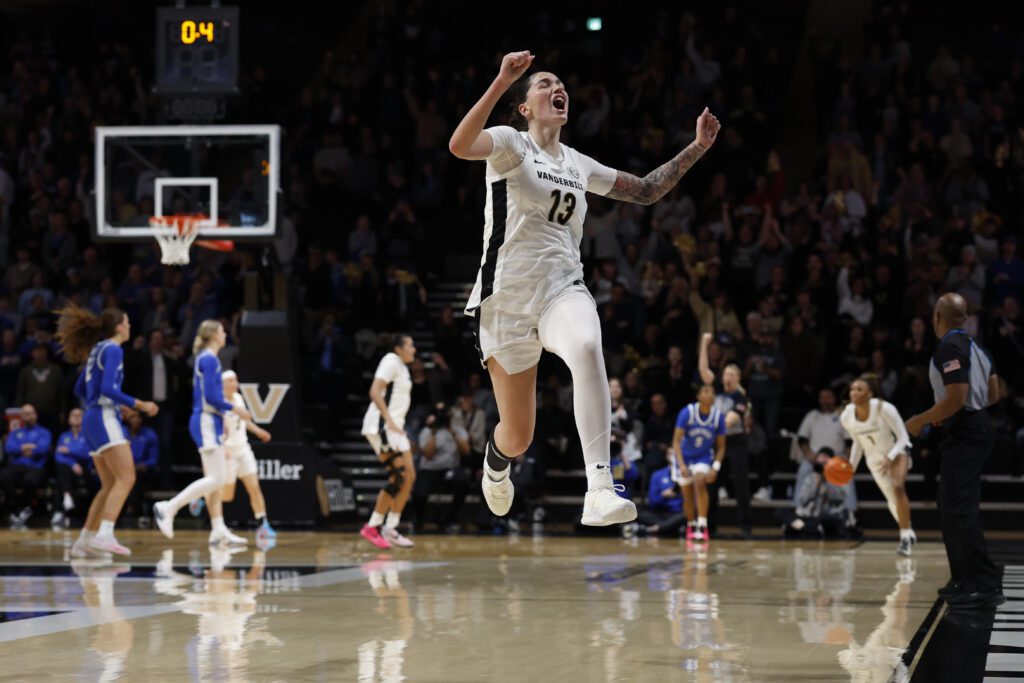 Vanderbilt guard Justine Pissott leaps in the air to celebrate a game-winning steal during a 2025/26 NCAA basketball game.