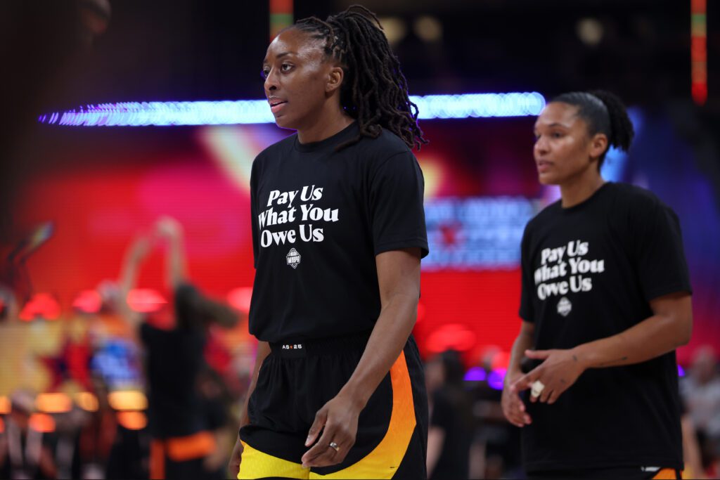 WNBA forwards Nneka Ogwumike and Alyssa Thomas enter the 2025 All-Star Game wearing T-shirts that say "Pay Us What You Owe Us."