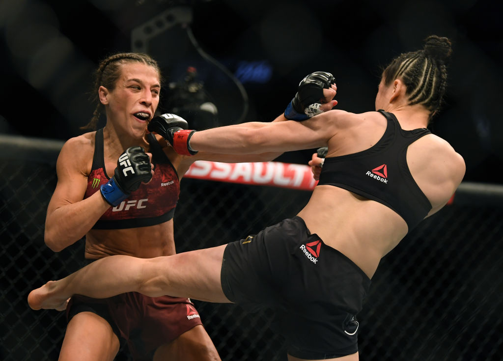 Joanna Jedrzejczyk punches Weili Zhang in a split decision loss during a strawweight title bout at T-Mobile Arena on March 07, 2020 in Las Vegas, Nevada.