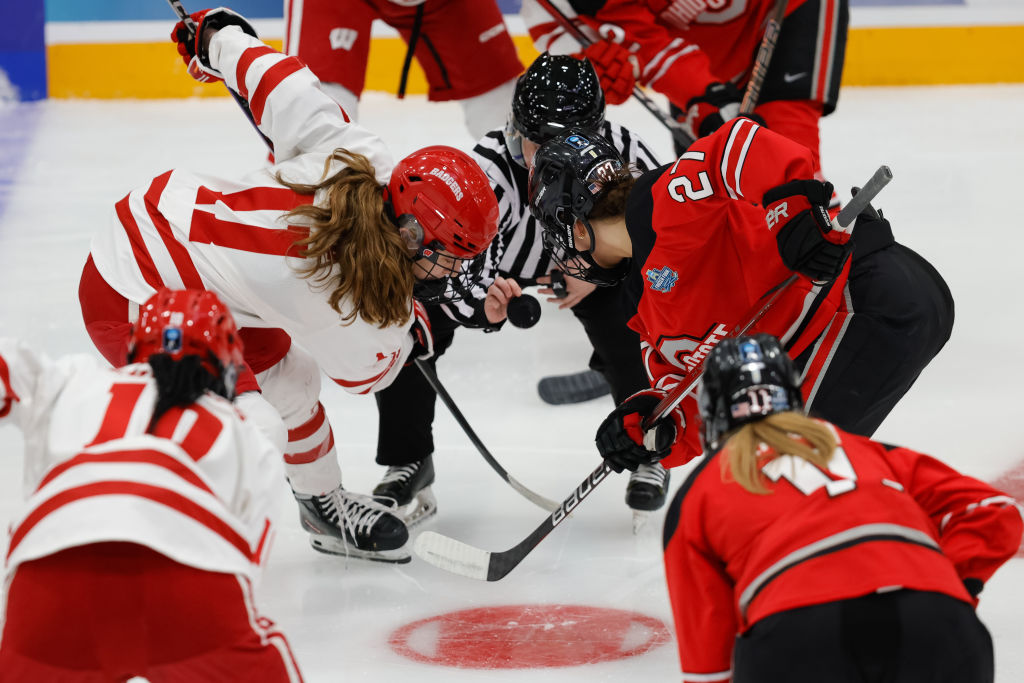 ESPN+ broadcast shows Ohio State Buckeyes forward Jordan Baxter (27) takes a face-off against Wisconsin Badgers forward Cassie Hall (11) during the first period of the Women's Frozen Four Championship game between the Ohio State Buckeyes and the Wisconsin Badgers on March 23rd, 2025, at Ridder Arena in Minneapolis, MN.