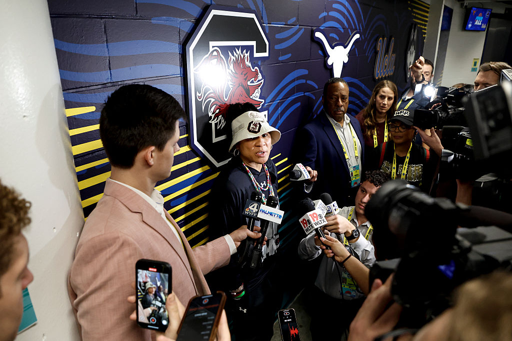 Head Coach Dawn Staley of South Carolina Women's Basketball talks with media during a press conference outside the locker room ahead of the Iran military strikes.