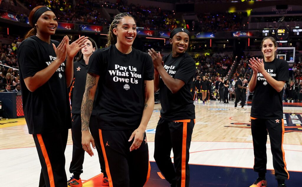 Washington Mystics rookies Kiki Iriafen and Sonia Citron as well as Las Vegas Aces guard Jackie Young clap for Seattle Storm star Gabby Williams ahead of the 2025 WNBA All-Star Game.