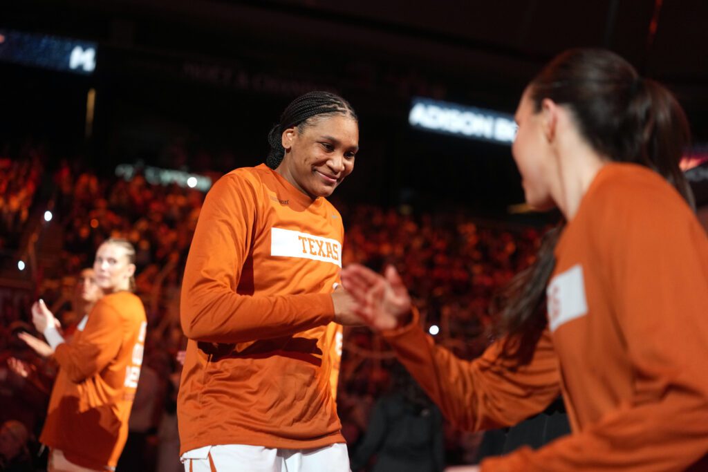 Texas forward Madison Booker high-fives a teammate as she's introduced before a 2025/26 NCAA basketball game.