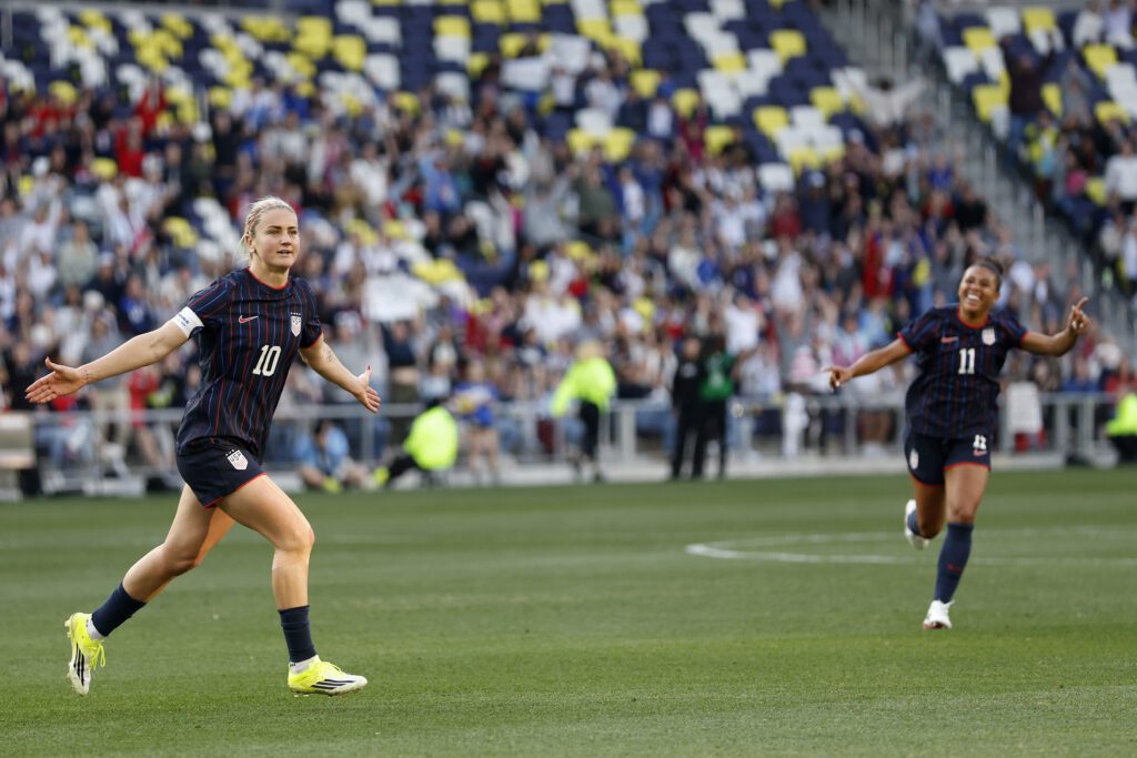 USWNT captain Lindsey Heaps and defender Kennedy Wesley run across the pitch to celebrate Heaps's goal during a 2026 SheBelieves Cup match.