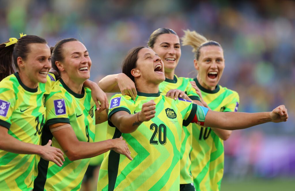 Australia captain Sam Kerr celebrates with teammates Hayley Raso, Caitlin Foord, Stephanie Catley, and Emily van Egmond after scoring in the 2026 AFC Women's Asian Cup.
