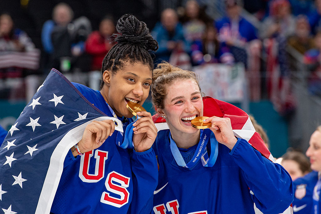 Laila Edwards #10 of United States and Caroline Harvey #4 of United States pose for a photo with gold medal during the Women's Gold Medal match between United States and Canada on day thirteen of the Milano Cortina 2026 Winter Olympic games at Milano Santagiulia Ice Hockey Arena on February 19, 2026 in Milan, Italy.