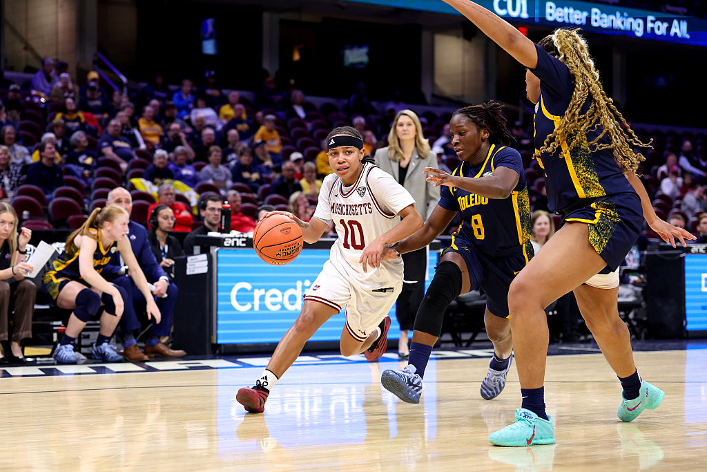 UMass Minutemen guard Yahmani McKayle (10) drives to the basket as Toledo Rockets guard Patricia Anumgba (8) and Toledo Rockets forward Miriam Diala (21) defend during the second quarter of the MAC Women's Basketball Tournament Quarterfinal game between the UMass Minutemen and Toledo Rockets on March 11, 2026, at Rocket Arena in Cleveland, OH.
