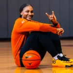 Texas women's basketball forward Madison Booker poses wearing Kevin Durant's player exclusive Nike sneakers as part of an NIL deal.