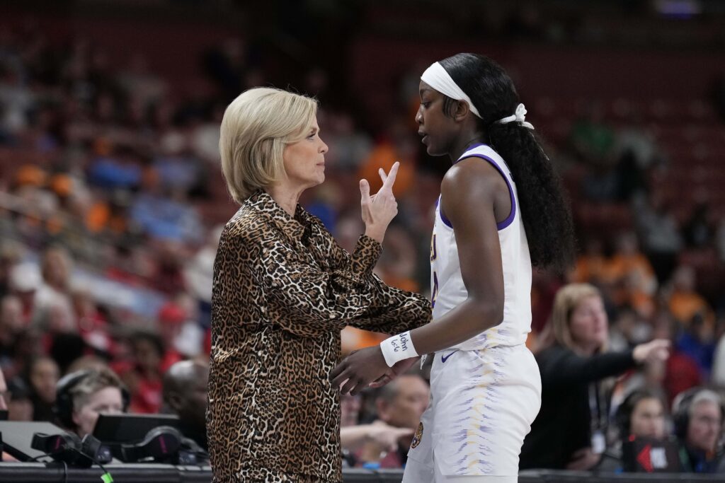 March Madness LSU Lady Tigers head coach Kim Mulkey talks with guard Flau'jae Johnson (4) in the first quarter against the Georgia Lady Bulldogs at Bon Secours Wellness Arena. 