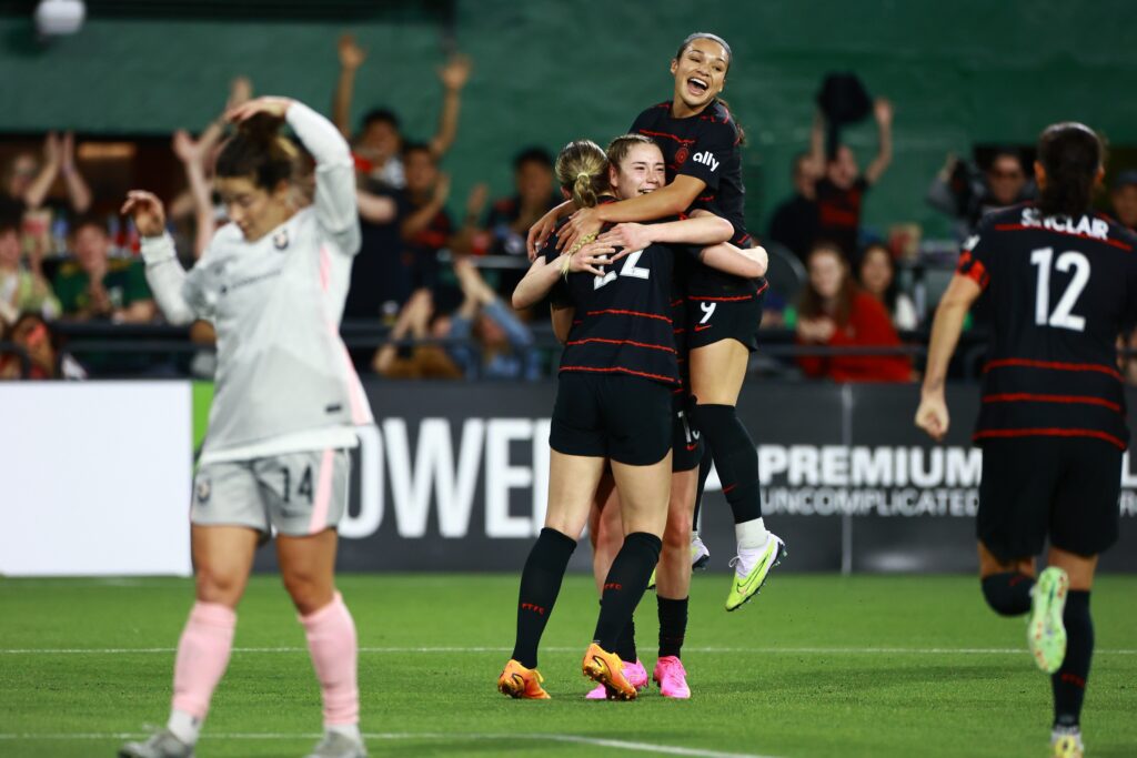 Portland Thorns FC forward Morgan Weaver (22), midfielder Olivia Moultrie (13) forward Sophia Wilson (9) react to a goal against Angel City FC during the second half at Providence Park. 