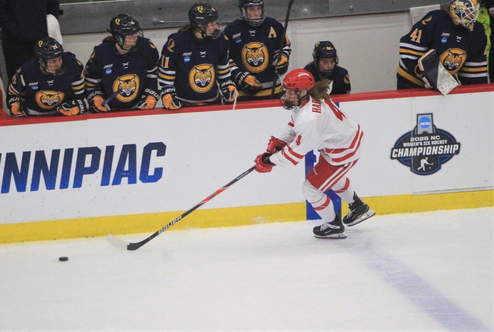 Wisconsin hockey Caroline Harvey controls the puck in front of the Quinnipiac bench during a NCAA regional final Saturday March 14, 2026 at LaBahn Arena in Madison, Wis.