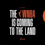 A graphic shows a hand reaching up for a basketball and the WNBA logo projected on Cleveland landmark Tower City while announcing "The WNBA is coming to The Land."
