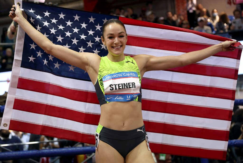 Abby Steiner poses with the American Flag after winning the Sherri & Brett Miller Women's Invitational 300 during the 115th Millrose Games at The Armory Track on February 11, 2023 in New York City.