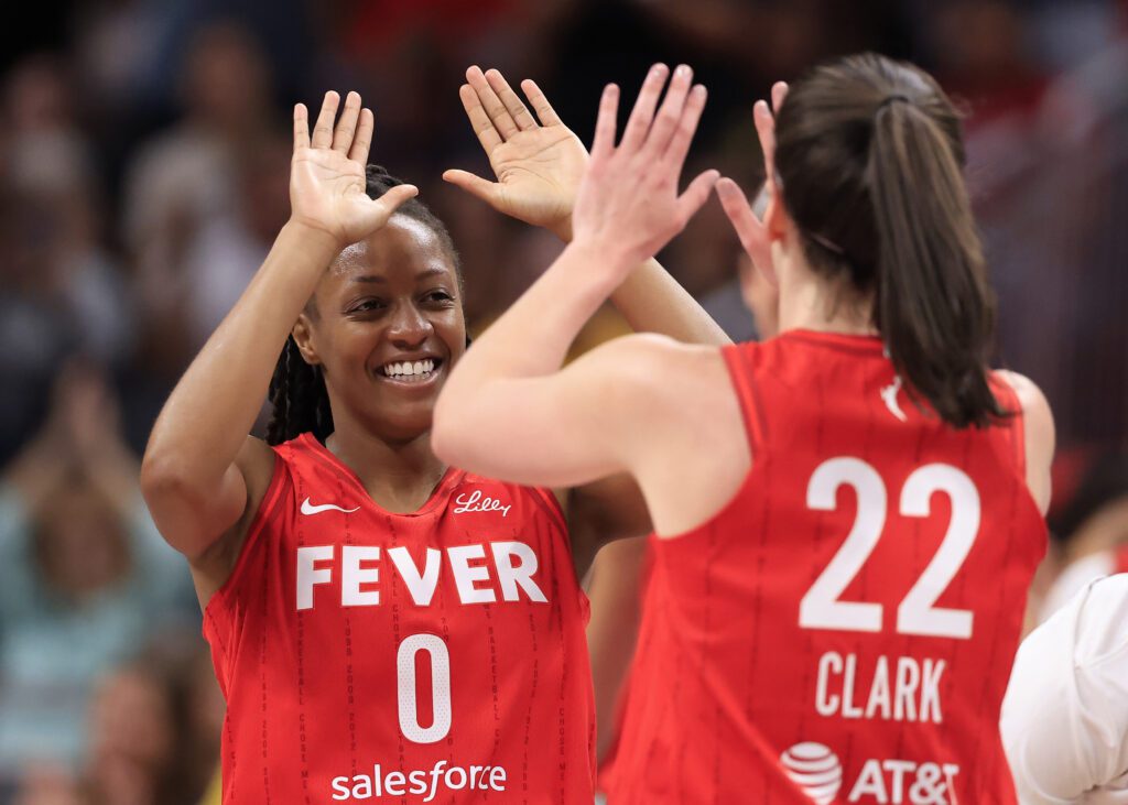 WNBA free agency candidate Kelsey Mitchell #0 of the Indiana Fever celebrates with Caitlin Clark #22 of the Indiana Fever during the first half against the Phoenix Mercury at Gainbridge Fieldhouse on August 16, 2024 in Indianapolis, Indiana.