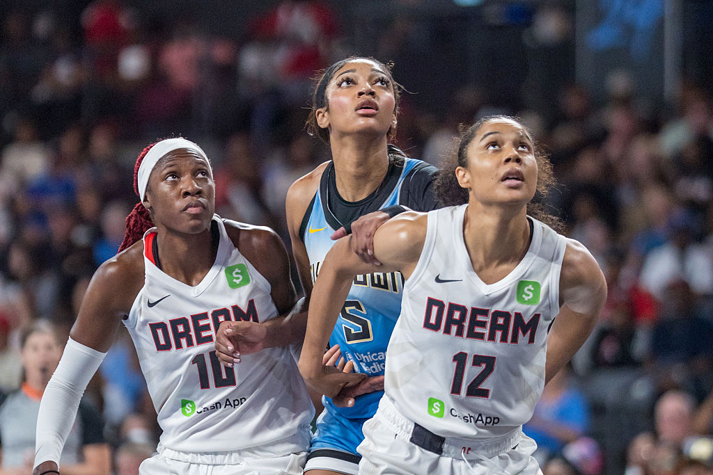 Rhyne Howard #10 of the Atlanta Dream, Nia Coffey #12 of the Atlanta Dream guard Angel Reese #5 of the Chicago Sky during a free throw during a game between the Chicago Sky and Atlanta Dream at Gateway Center Arena on June 22, 2025 in College Park, Georgia.