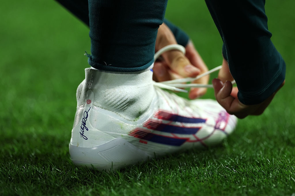 NWSL brands detail as Trinity Rodman #2 of Washington Spirit ties back her boot during the NWSL match between Washington Spirit and Portland Thorns FC at Audi Field on March 13, 2026 in Washington, DC.