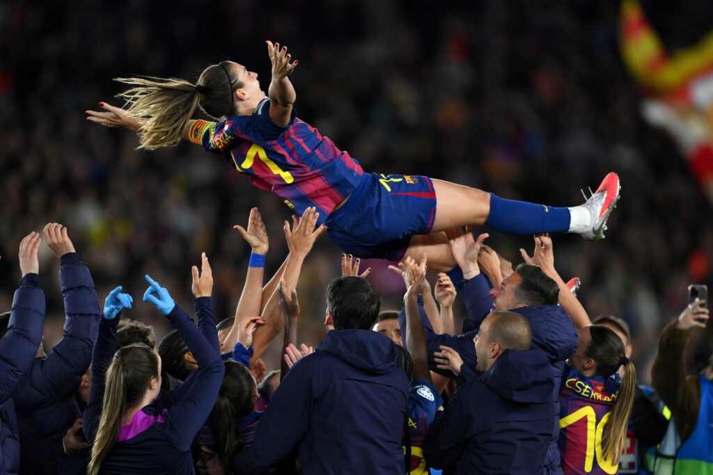 Alexia Putellas of FC Barcelona is thrown in the air in celebration by team mates and staff following the team's 6-0 victory in her 500th club appearance in the UEFA Women's Champions League 2025/26 Quarter-finals Second Leg match between FC Barcelona and Real Madrid CF at Nou Camp on April 02, 2026 in Barcelona, Spain.